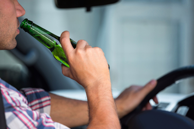 Man Driving Drinking a beer