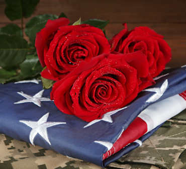 American Flag with roses laid on them